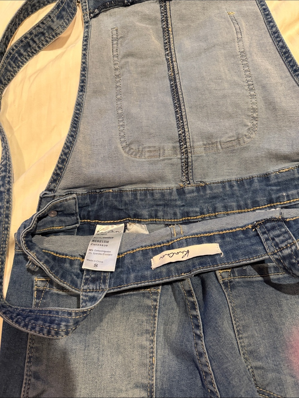KanCan Light Wash Denim Overalls in Faded Blue distressed